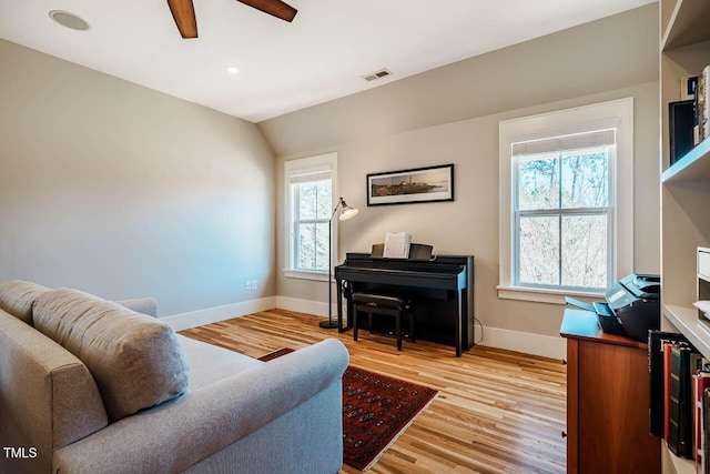 living room featuring baseboards, recessed lighting, visible vents, and light wood-style floors