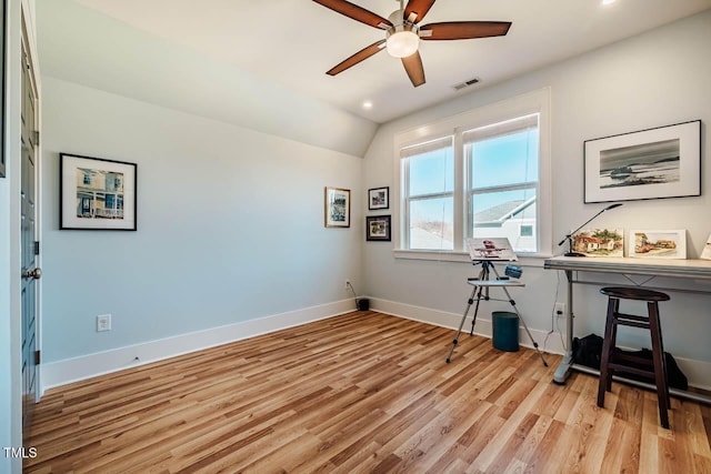 home office featuring lofted ceiling, visible vents, light wood-style flooring, ceiling fan, and baseboards