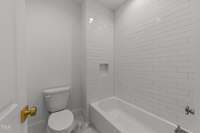 bathroom featuring bathtub / shower combination, toilet, and baseboards