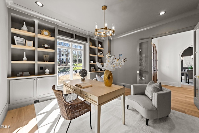 office featuring arched walkways, a chandelier, recessed lighting, baseboards, and light wood-type flooring