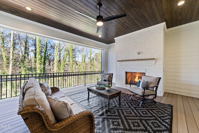 sunroom with an outdoor brick fireplace, a wealth of natural light, and wood ceiling