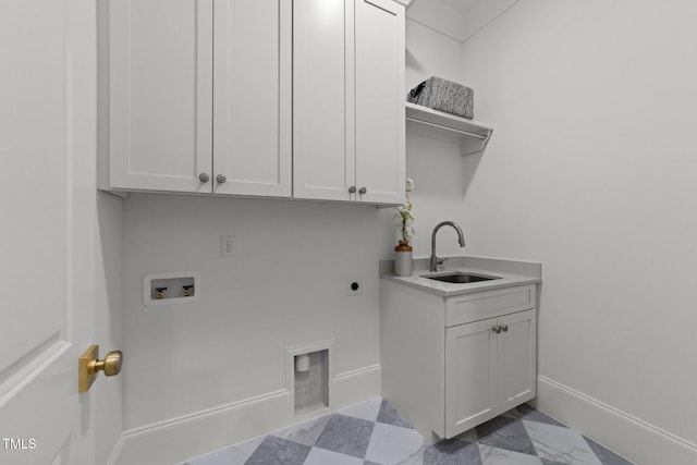 washroom featuring cabinet space, baseboards, a sink, washer hookup, and electric dryer hookup