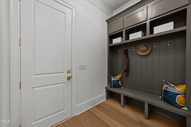 mudroom featuring baseboards and wood finished floors