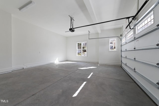 garage with baseboards and a garage door opener