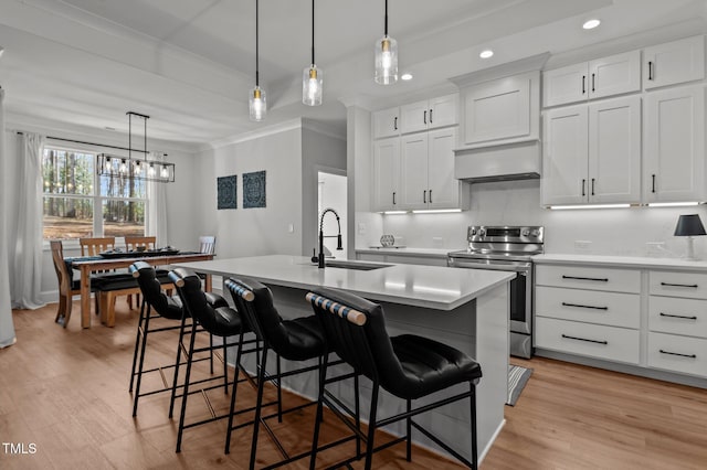 112 Rawhide Dr, Louisburg, NC 27549 - kitchen with light countertops, stainless steel range with electric stovetop, a sink, and wall chimney exhaust hood