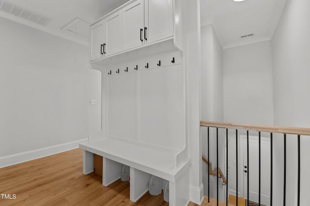 112 Rawhide Dr, Louisburg, NC 27549 - mudroom with crown molding, attic access, baseboards, visible vents, and light wood-style floors