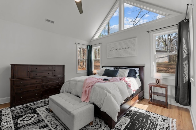 112 Rawhide Dr, Louisburg, NC 27549 - bedroom with light wood-style flooring, high vaulted ceiling, baseboards, visible vents, and a ceiling fan