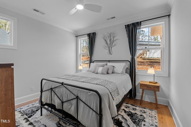 112 Rawhide Dr, Louisburg, NC 27549 - bedroom featuring visible vents, multiple windows, and wood finished floors