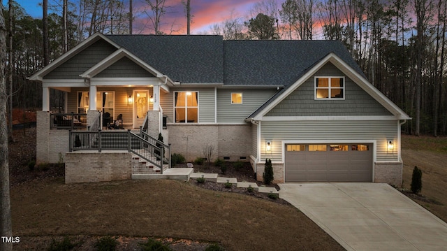 112 Rawhide Dr, Louisburg, NC 27549 - craftsman-style house featuring brick siding, a porch, concrete driveway, and a garage