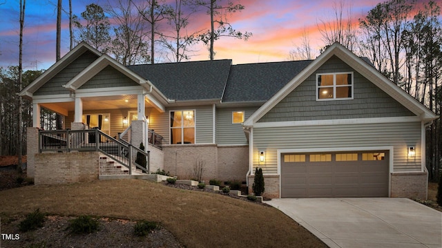 112 Rawhide Dr, Louisburg, NC 27549 - craftsman-style home with driveway, covered porch, brick siding, a garage, and a shingled roof