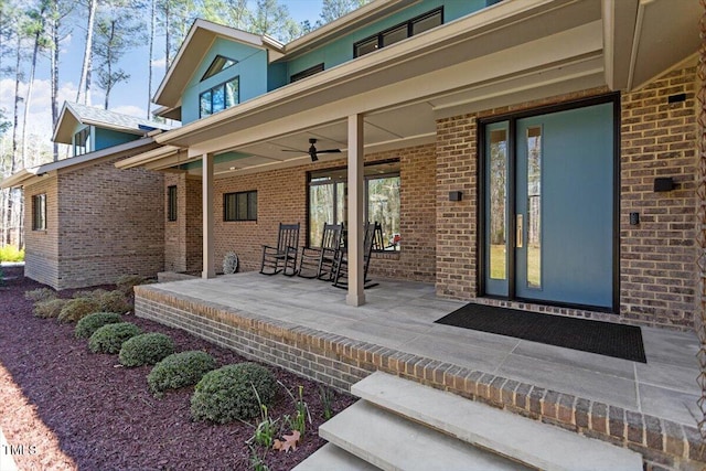 property entrance featuring brick siding and a porch