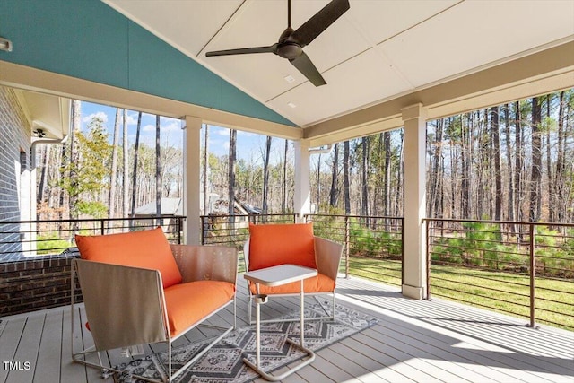 sunroom / solarium featuring vaulted ceiling and a ceiling fan