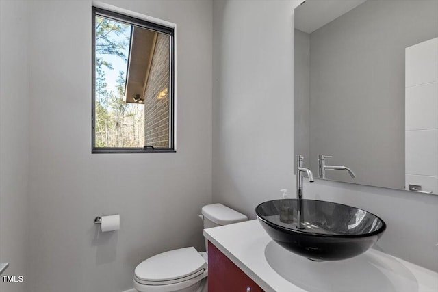 half bathroom featuring toilet and vanity