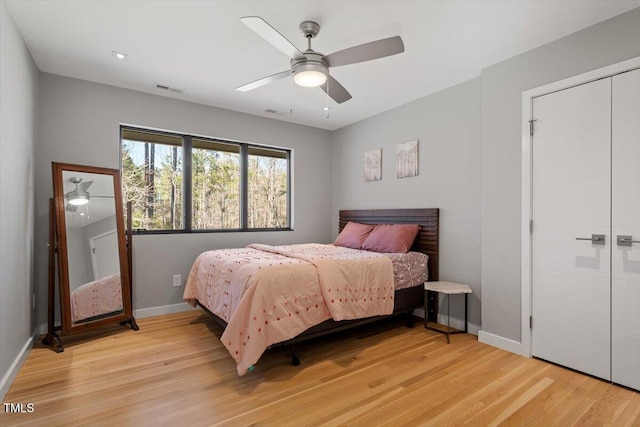 bedroom with visible vents, ceiling fan, baseboards, and light wood-style floors