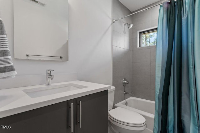 full bath featuring vanity, shower / bath combination with curtain, toilet, and visible vents