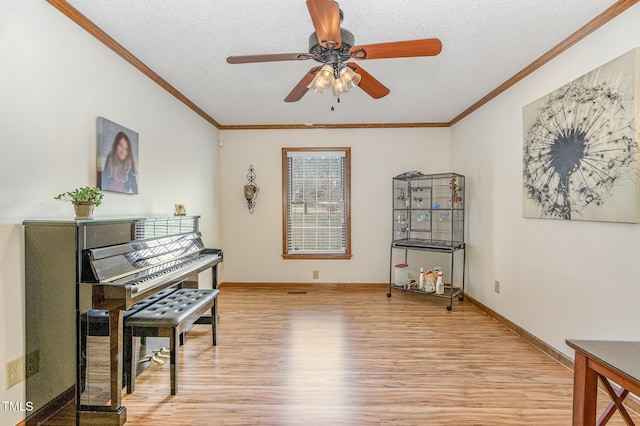 interior space featuring crown molding, light wood-style floors, and a textured ceiling