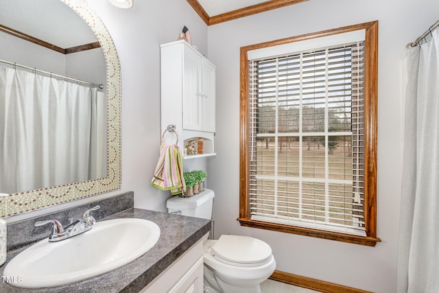 bathroom with a shower with curtain, toilet, vanity, and crown molding