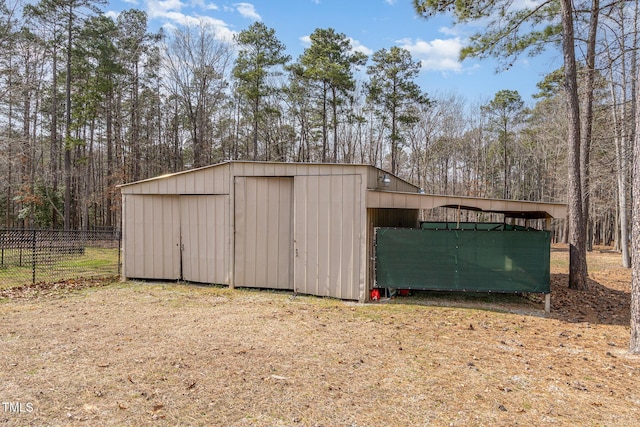 view of pole building with fence
