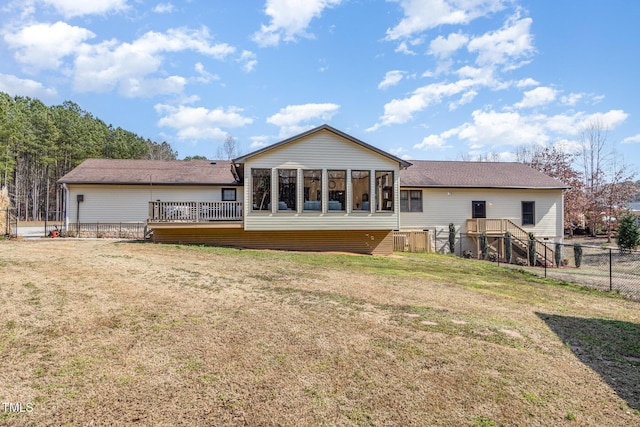 rear view of property with a yard, fence, and a shingled roof