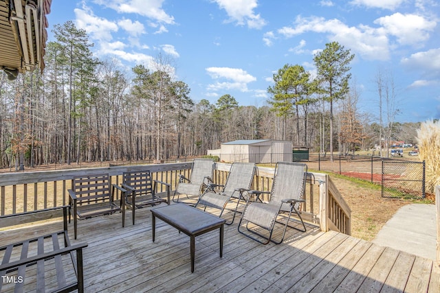 wooden deck featuring an outdoor structure and fence