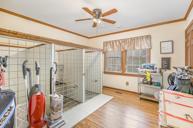 bathroom with visible vents, baseboards, ceiling fan, ornamental molding, and wood finished floors