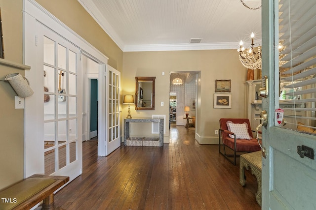 foyer entrance with a chandelier, visible vents, french doors, dark wood-style floors, and crown molding