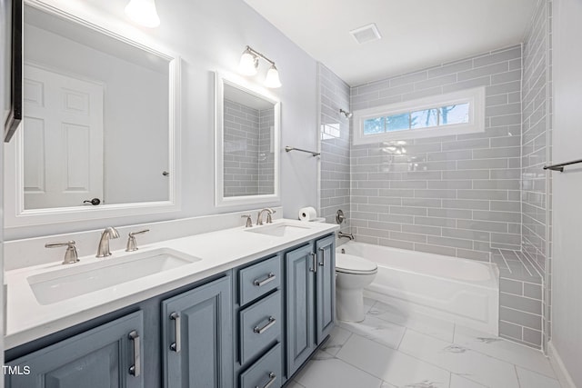 bathroom with a sink, visible vents, marble finish floor, and double vanity