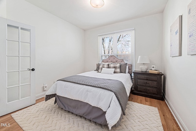 bedroom featuring baseboards and wood finished floors