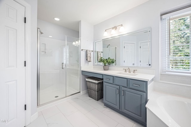 full bathroom with vanity, a bath, a stall shower, and marble finish floor