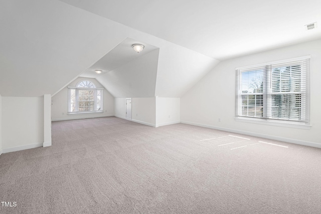 bonus room with visible vents, carpet floors, baseboards, and vaulted ceiling