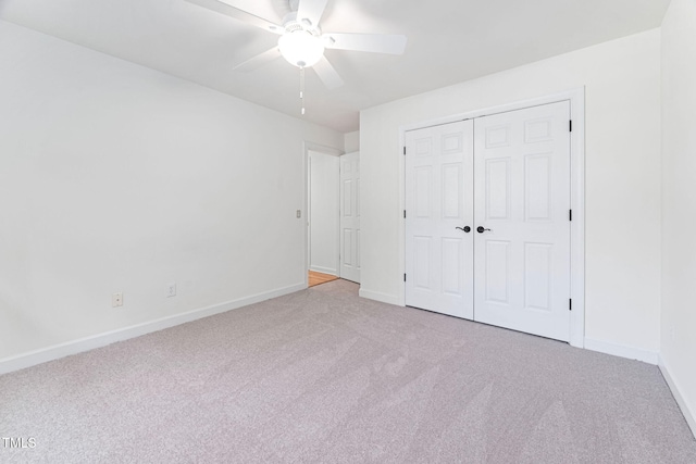 unfurnished bedroom with a ceiling fan, carpet, baseboards, and a closet