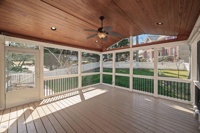 unfurnished sunroom featuring lofted ceiling, plenty of natural light, and wood ceiling