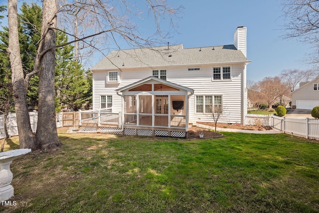 rear view of house with a deck, a fenced backyard, a yard, a sunroom, and a chimney