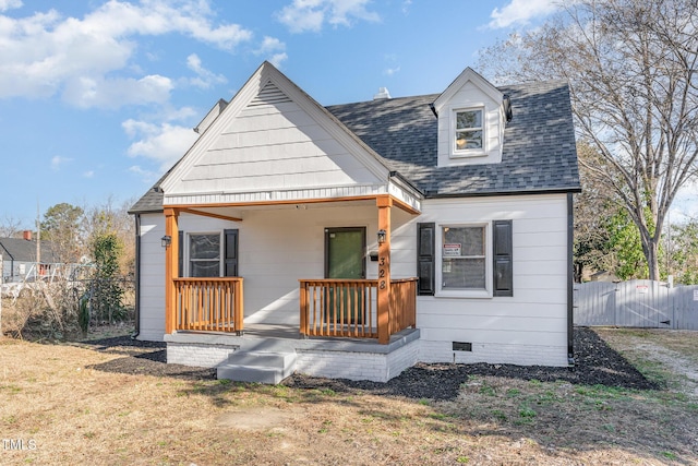 view of front of home with roof with shingles, crawl space, covered porch, a gate, and fence