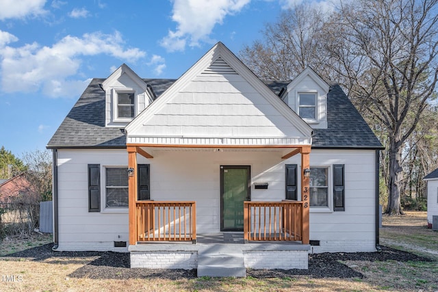 back of house featuring a porch, crawl space, and roof with shingles