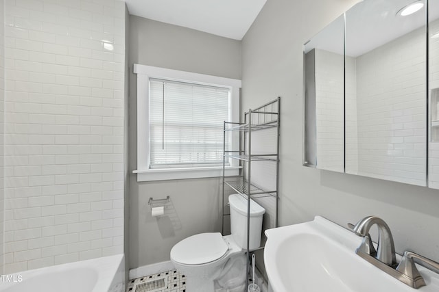 full bathroom with toilet, baseboards, a sink, and tile patterned floors