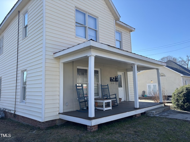 rear view of house featuring a porch