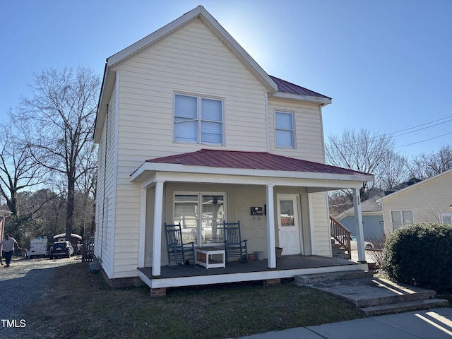 view of front of property featuring a porch and metal roof