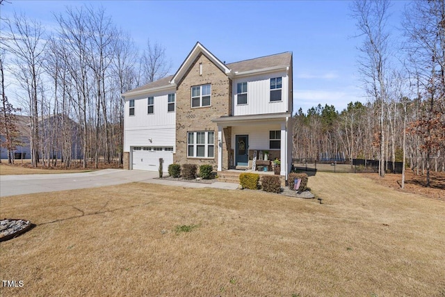 view of front of property featuring a front yard, covered porch, concrete driveway, and an attached garage