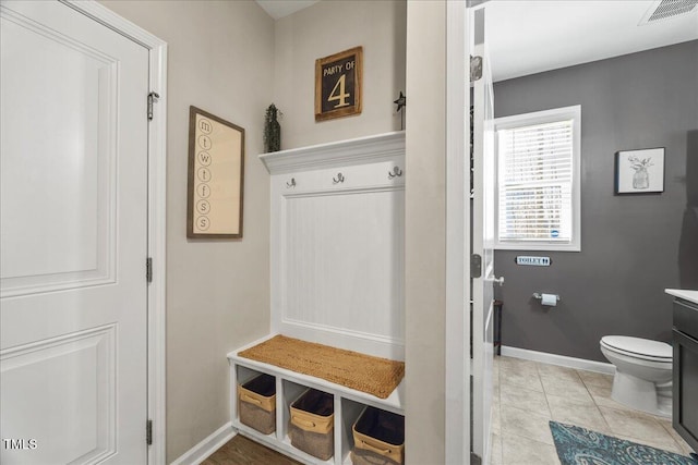 mudroom with visible vents, baseboards, and light tile patterned flooring