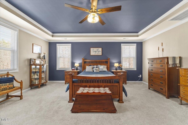 bedroom featuring a raised ceiling, visible vents, and light carpet