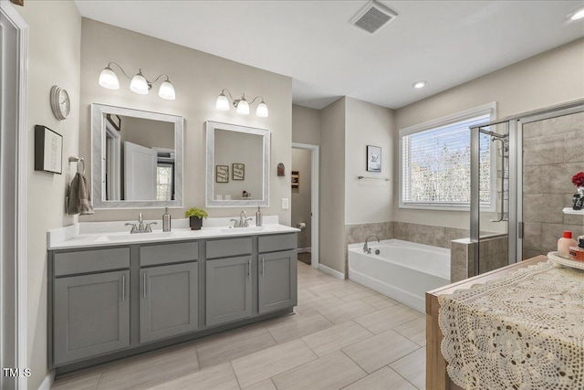 bathroom with a sink, visible vents, a stall shower, and a bath