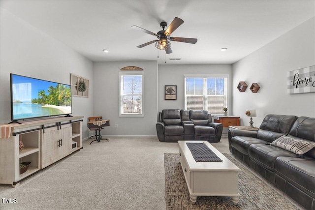 living area featuring a ceiling fan, visible vents, carpet, and baseboards