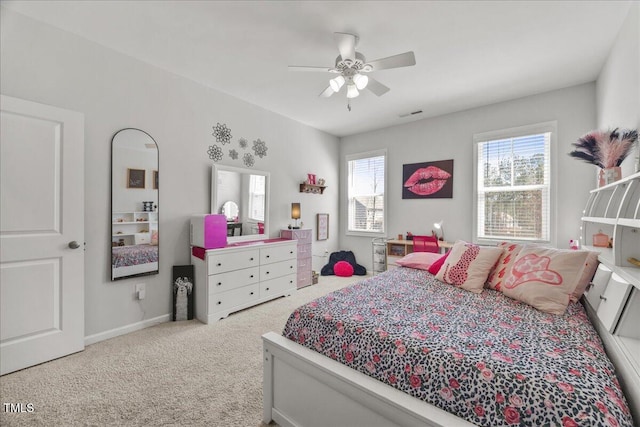 bedroom with carpet flooring, a ceiling fan, visible vents, and baseboards