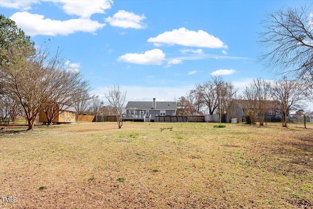 view of yard featuring a wooden deck and fence