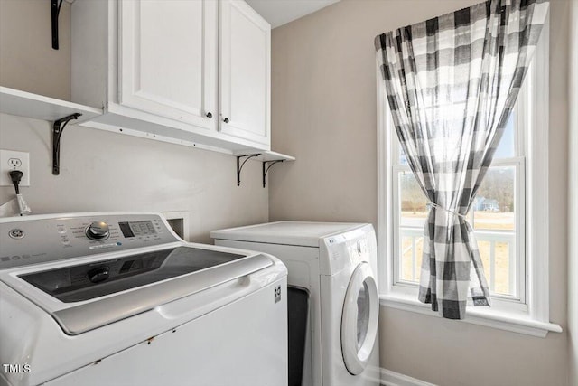 washroom featuring cabinet space and washing machine and dryer