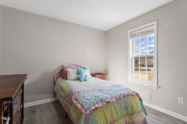 bedroom featuring baseboards and wood finished floors