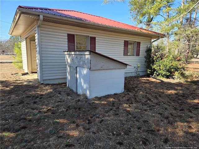 rear view of house with metal roof