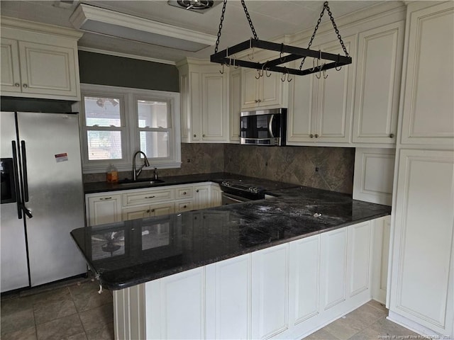 kitchen with tasteful backsplash, appliances with stainless steel finishes, ornamental molding, a sink, and a peninsula