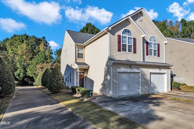 traditional home with driveway and an attached garage